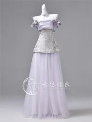 A long light purple dress with one-shoulder strapless design that exudes luxurious toasting vibe
