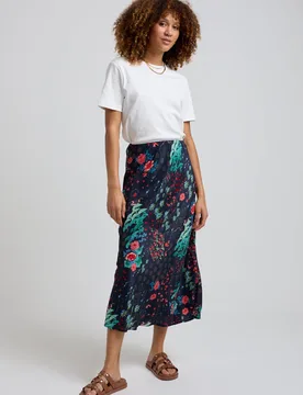 Ivy Bias Cut Wonderland Print Midi Skirt In Black - 8 - Lily and Lionel London Limited - FashionsVida