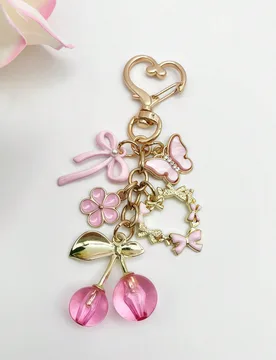 Pieza/2 piezas Llavero colgante de viaje elegante y de moda con lazo rosa, accesorio grande con forma de cereza con decoración de flor rosa, hebilla - Shein - FashionsVida