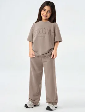 Conjunto de camiseta de cuello redondo, hombros caídos, manga corta y pantalones holgados, casual, minimalista y cómodo para niña preadolescente - Shein - FashionsVida