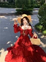 A long-sleeved red dress with halter neck and one-shoulder design that makes the skin fairer